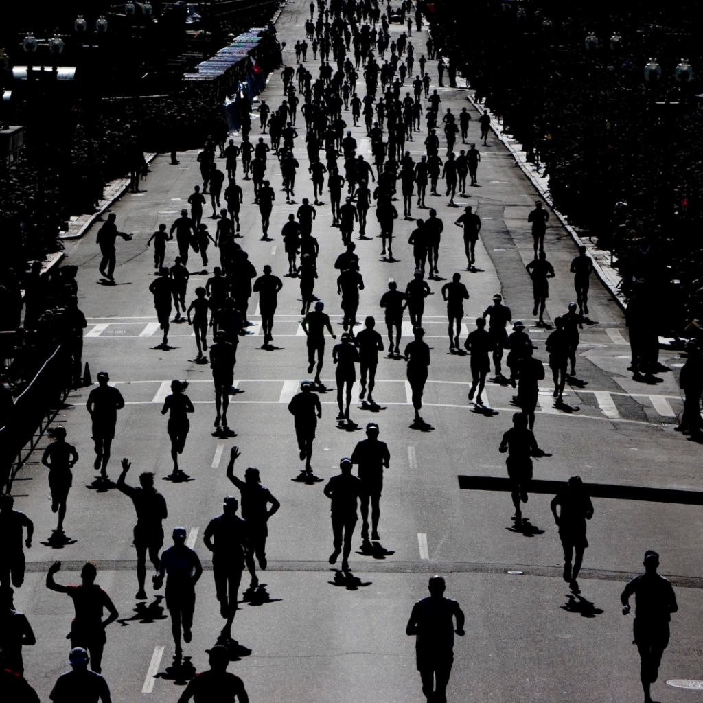 people running in a race down a city street